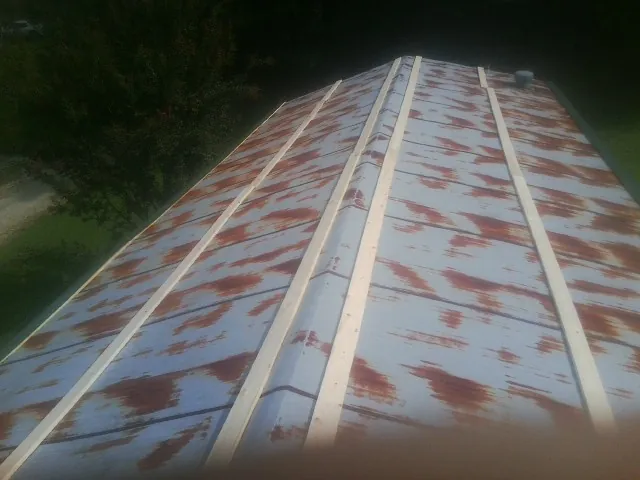 Rusted metal roof panels with new wood purlins before replacement — Storm Damage Roof Repair in Daufuskie Island by Roofing Brothers