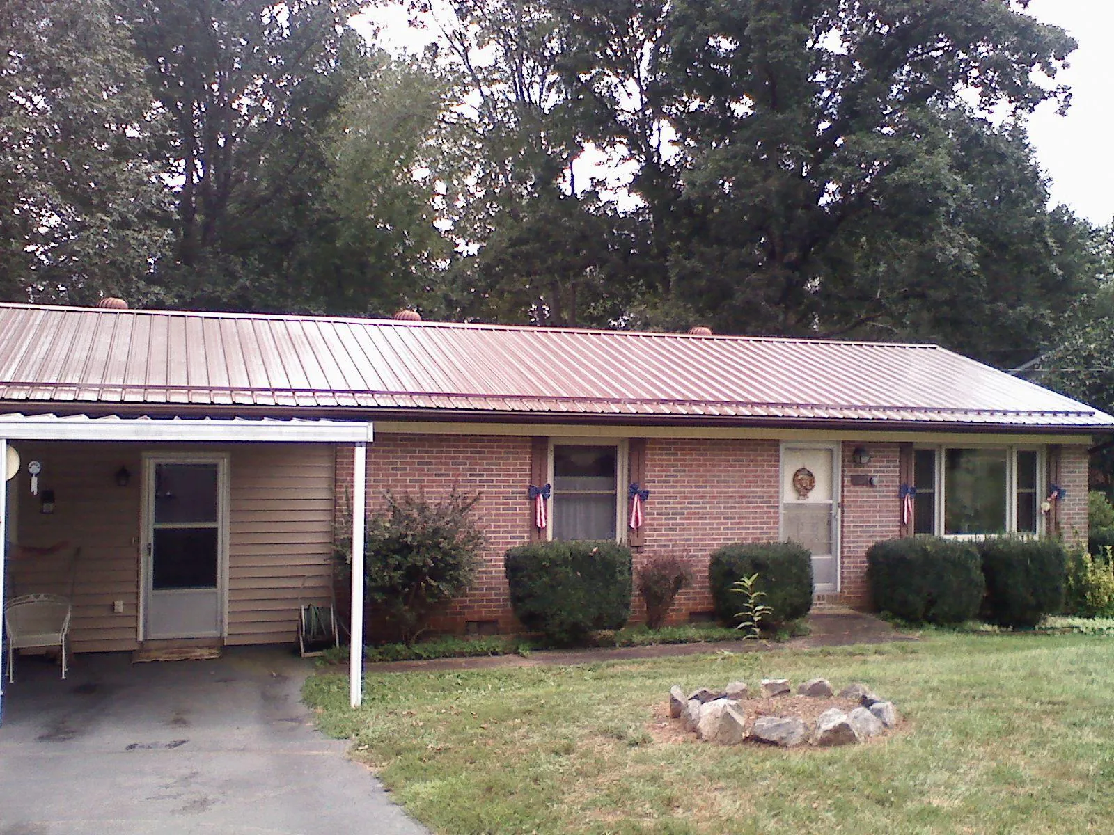 Bronze metal roof and carport on a brick ranch home — Roof Repair work by our crew in Daufuskie Island